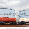 stock-photo--train-wagons-and-oil-and-fuel-storage-tanks-79182889