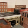 HO factory background test: HO flat among O scale flats.  Not ideal placement, but gives a view of how it could fit in.  And, a sentimental favorite.