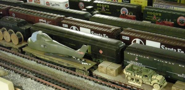 Military CH-34 and half-track on flat cars