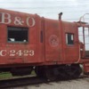An ex-B&amp;O caboose parked in front of the roundhouse
