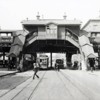 116th Street, looking west from east of Third Avenue. Ride On the Open Air Elevated written on the side of the El station, as a trolley approaches, on October 8, 1925 92kb